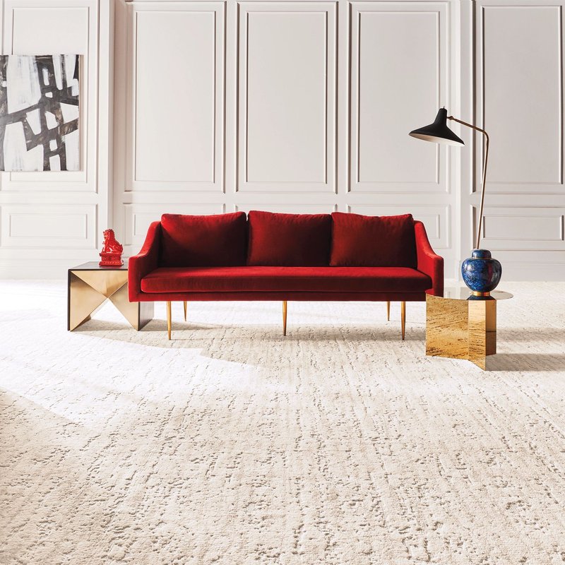 A red couch on a red carpet from Fleeners Home Planning Inc in Leitchfield, KY